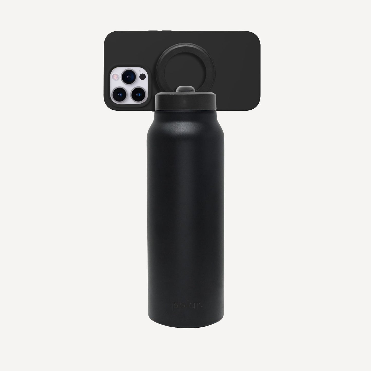 Carbon magnetic water bottle with phone mount used as a tripod for filming and hands-free content viewing