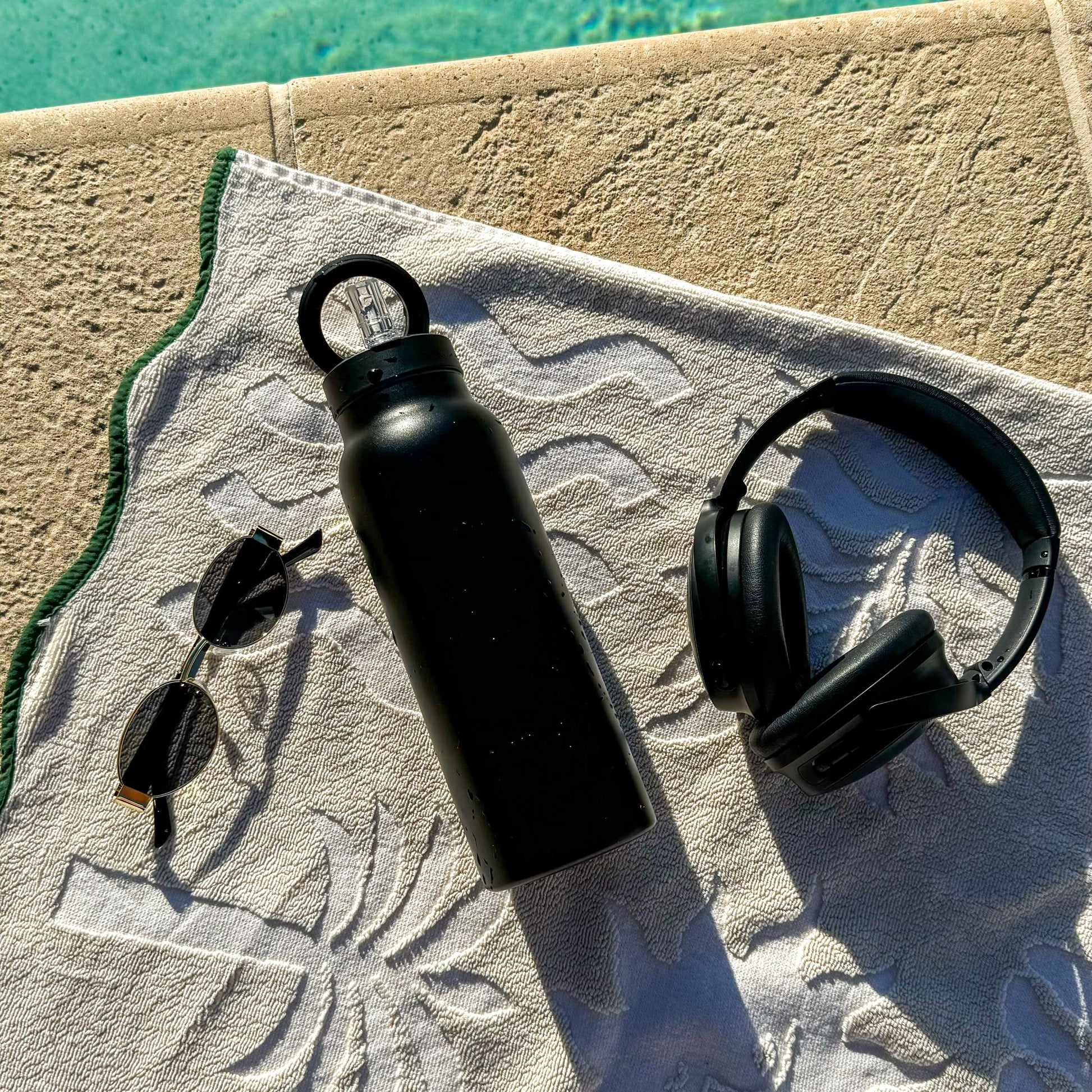 Black magnetic water bottle with phone holder used for workouts, travel and everyday carry