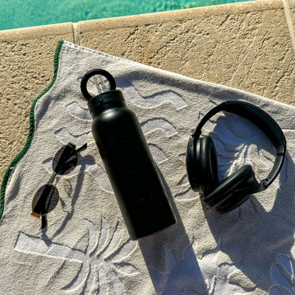 Black magnetic water bottle with phone holder used for workouts, travel and everyday carry