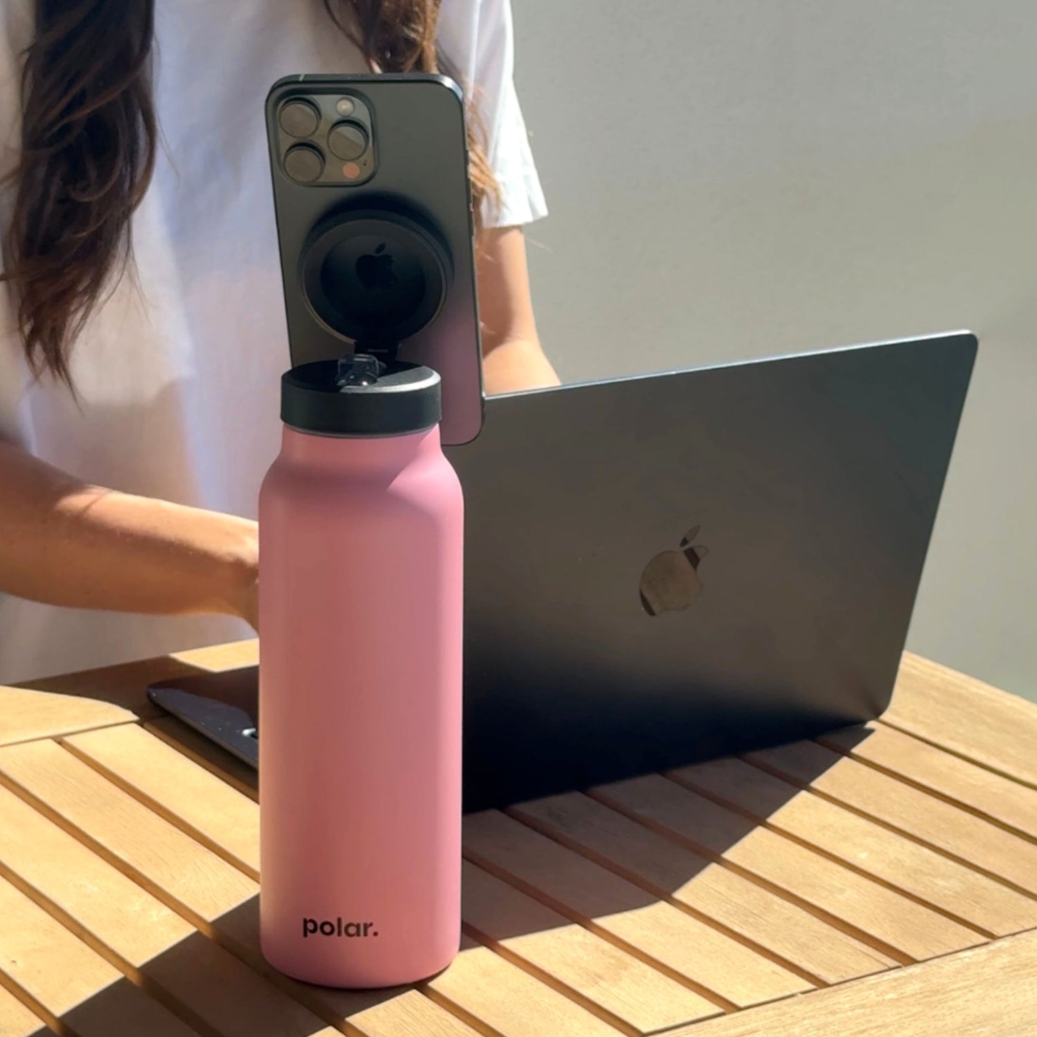 Magnetic water bottle with phone holder used as a desk stand for hands-free video calls and working from home