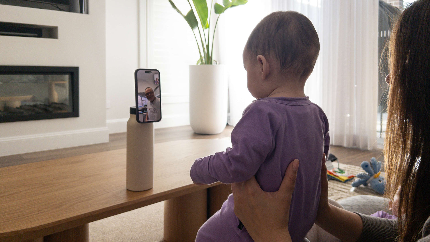 Magnetic water bottle with phone mount used as a desk setup for hands-free content viewing and productivity