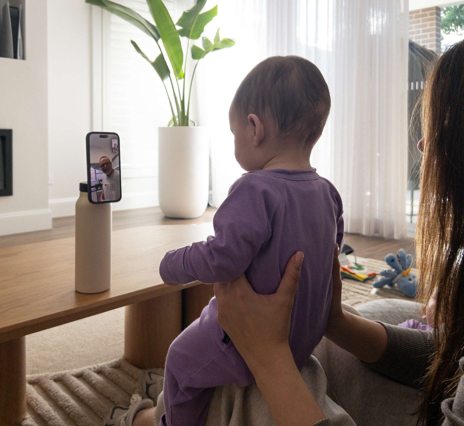 Magnetic water bottle phone stand used at home for hands-free viewing while managing everyday family life