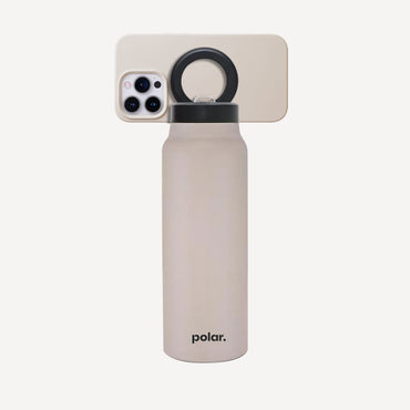 Sand magnetic water bottle with phone mount used as a hands-free stand for viewing content and everyday use