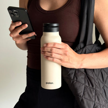 Sand magnetic water bottle with phone mount used on the go for hands-free viewing and everyday use