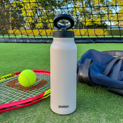 Sand magnetic water bottle with phone holder used courtside as a tripod for recording training and watching drills