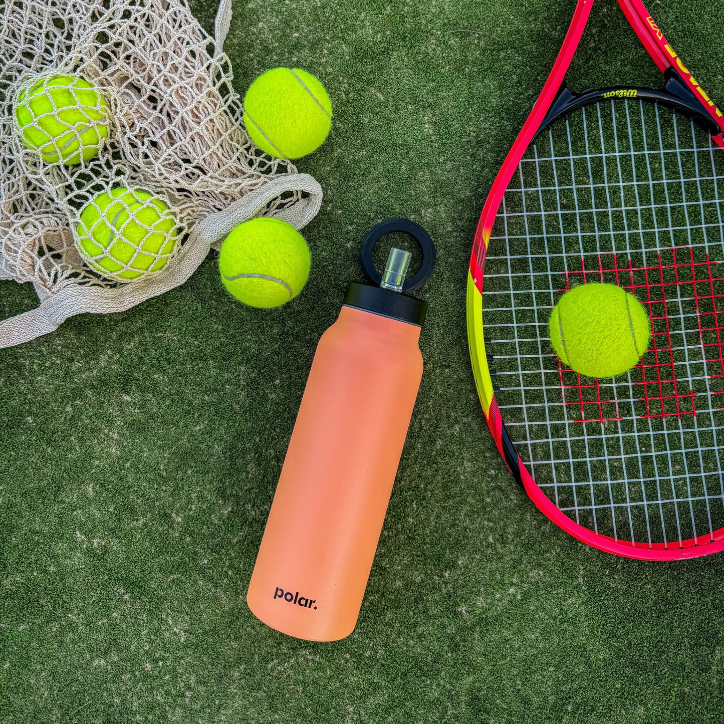Sundust magnetic water bottle with phone holder used for hands-free workouts on a tennis court